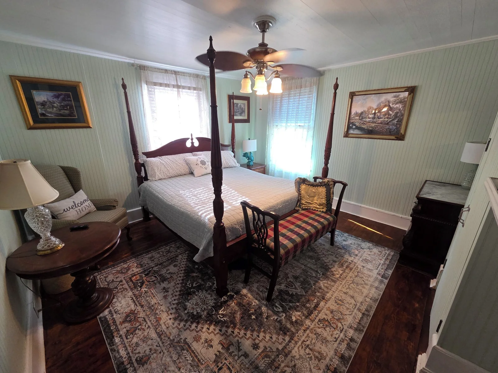 Spacious bedroom with a four-poster bed and historic furnishings